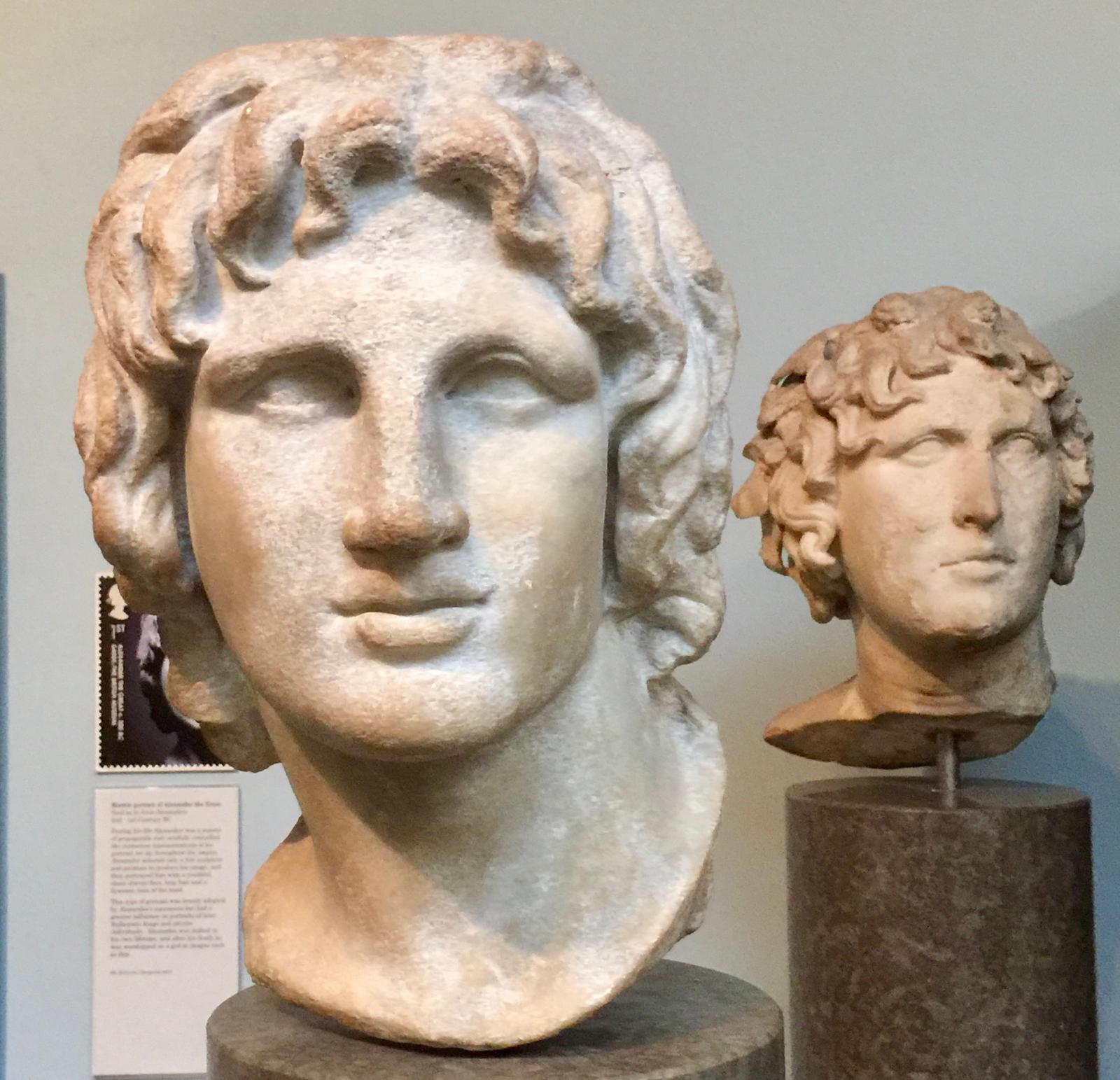A marble portrait head of Alexander the Great, with a second Hellenistic head behind it.