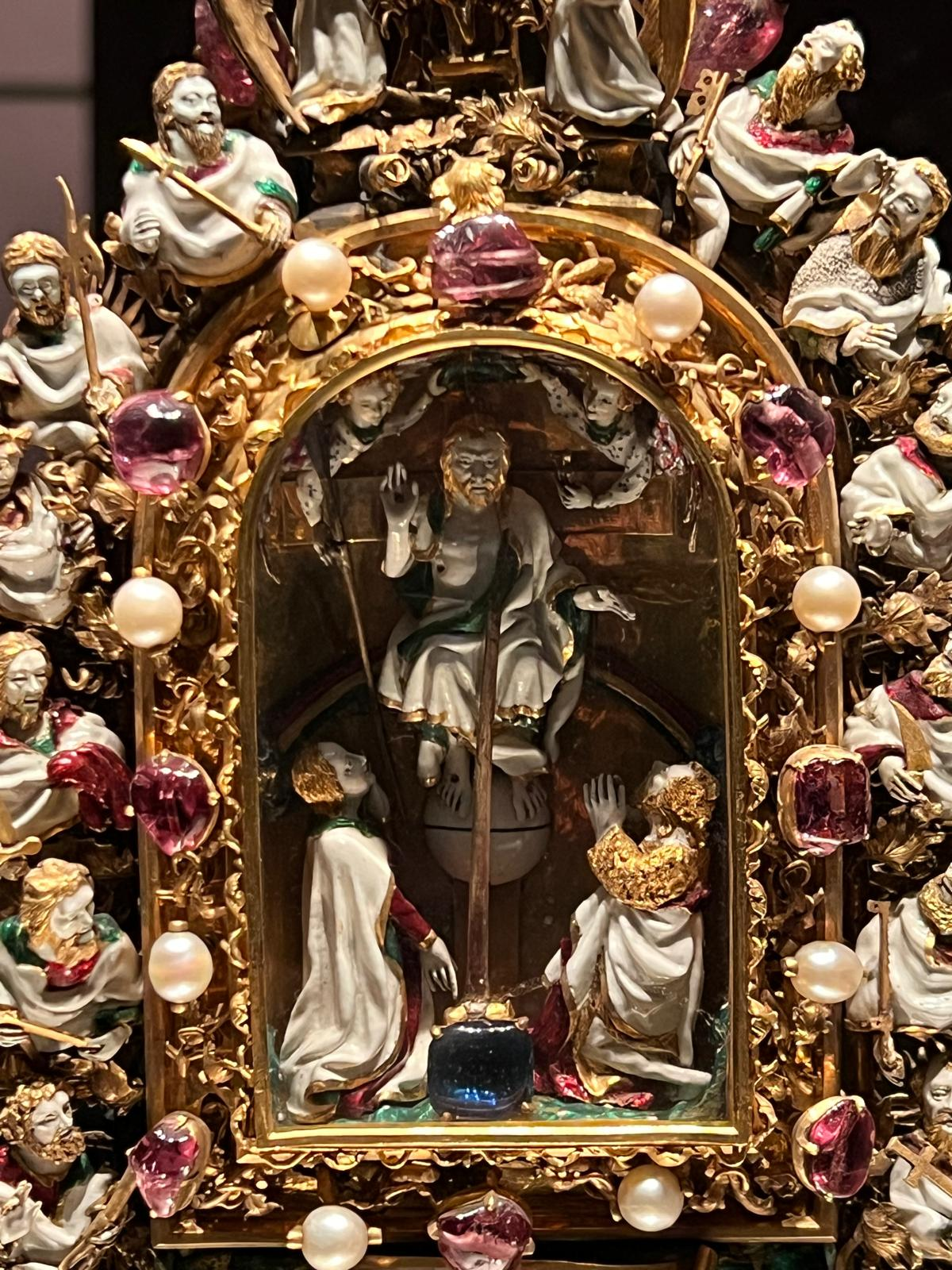 A close-up of the Holy Thorn Reliquary, with an enamel figure of Christ enthroned and the apostles around the jewelled frame.